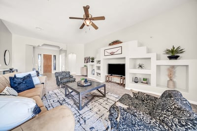 Warm and welcoming great room with vaulted ceilings, decorative built-in niches, and plenty of space for entertaining guests or relaxing with family. The open floor plan enhances both comfort and functionality.