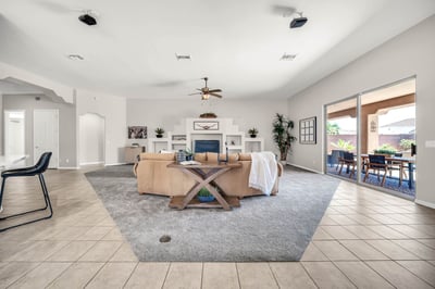 Expansive living room with custom architectural details, generous seating space, and direct access to the backyard retreat. This open layout is perfect for hosting gatherings or enjoying everyday comfort.