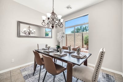 Light-filled dining room featuring modern lighting, oversized windows, and ample room for hosting family meals and special occasions. Conveniently located adjacent to the kitchen for effortless entertaining.