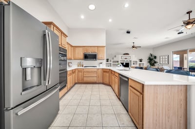 Spacious kitchen with stainless appliances, plentiful cabinetry, expansive counters, and an open layout connecting seamlessly to the great room. A perfect gathering place for everyday living.