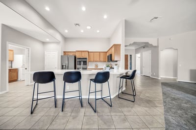 The oversized peninsula with seating overlooks the great room, making this kitchen ideal for entertaining and everyday living. Featuring a gas cooktop, double ovens, and an open-concept design, this Goodyear home blends style with functionality.