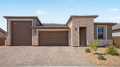 Clean architectural lines, stone veneer, covered entry, and oversized garage spaces create an impressive front elevation. Low-maintenance landscaping enhances the home's modern design and easy-care lifestyle.