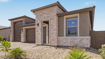 Professionally landscaped front yard, modern architecture, and premium stone accents combine to create an attractive exterior designed for low-maintenance living in Wittman.