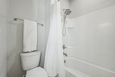 Clean and inviting full bathroom featuring a tub/shower combination, updated fixtures, and bright finishes. A functional space designed to comfortably serve family members and guests.