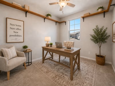 Virtually Staged Bright secondary bedroom with plush carpeting, ceiling fan, custom open shelving, and a large window. Perfect as a guest room, home office, or hobby space in this beautiful Wittman residence.
