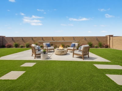 Virtually Staged Spacious outdoor entertaining area with artificial turf, a large concrete patio surrounding the fire pit, decorative wall feature, and plenty of room for outdoor furniture and gatherings.