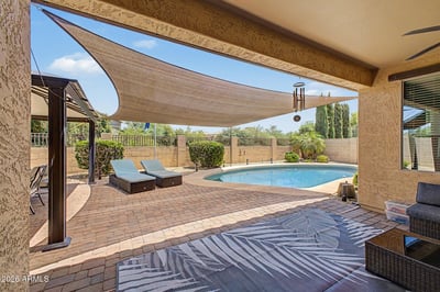 Experience Arizona outdoor living with a sparkling pool, covered patio, shade sail, paver entertaining area, and private greenbelt views. This inviting backyard is designed for relaxing weekends and effortless entertaining.