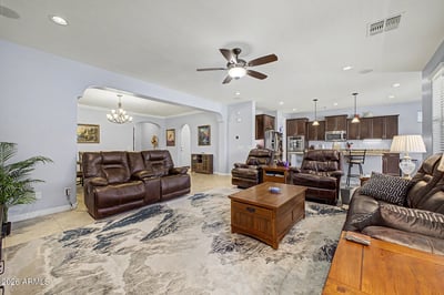 The expansive great room offers comfortable seating, recessed lighting, and an open layout that connects beautifully with the kitchen. Perfect for gathering with family or hosting guests in style.