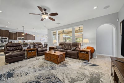 Gather in this spacious great room featuring oversized windows, recessed lighting, ceiling fan, and an open layout flowing effortlessly into the kitchen. Designed for entertaining and comfortable everyday living.