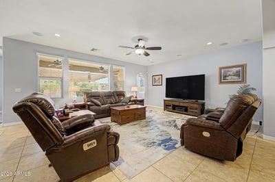 The welcoming great room offers generous seating space, abundant natural light, and an open-concept design that connects beautifully with the kitchen and dining areas, creating an inviting atmosphere throughout the home.