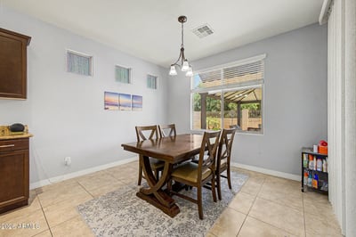 Natural light fills this cheerful breakfast nook overlooking the backyard and covered patio. Its convenient location beside the kitchen makes it perfect for casual meals and everyday living.
