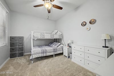 Complete with storage cabinets, countertop workspace, shelving, and space for full-size laundry appliances, this functional laundry room adds convenience to everyday living in Goodyear.