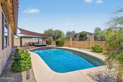 Enjoy Arizona living with a sparkling private pool surrounded by attractive landscaping, open patio areas, and outdoor entertaining spaces. A highlight of this rental home in Goodyear.