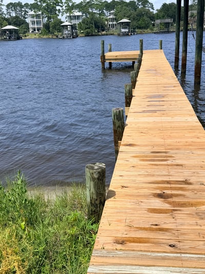 Inviting waterfront property featuring a spacious dock, perfect for boating and enjoying scenic water views.