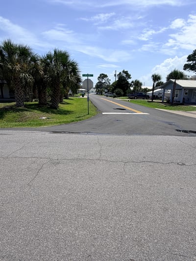 Vacant lot in a welcoming neighborhood, ready for your dream home near scenic palm trees.