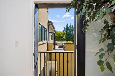Juliet balcony overlooks the deck off the kitchen and the patio garden below.