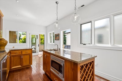Large center island with built-in microwave, wine rack and second sink.