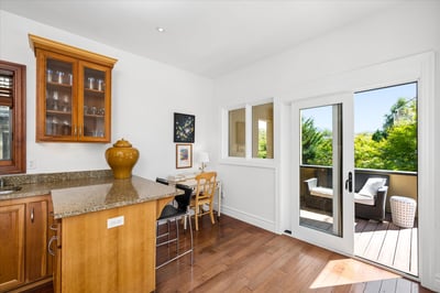 This space flows seamlessly to a private, partially covered outdoor terrace featuring newer Trex decking complete with a gas BBQ hook up for year-round entertaining.
