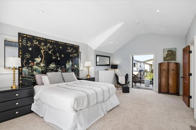The elegant primary suite offers vaulted ceilings with French doors leading to a large private terrace--a perfect place to sit and watch the sunset.