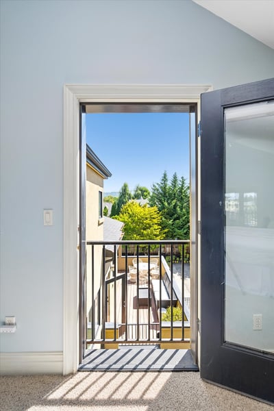This Juliet balcony overlooks the same spaces as the one below in the dining room; the wrap-around deck off the kitchen and the patio garden below.