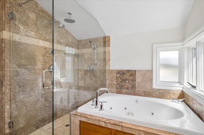 Relaxing jetted tub and walk-in shower with dual showers plus a rain shower.