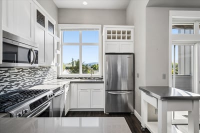 Quartz counters,KitchenAid, stainless steel appliance, gas range, built-in microwave.