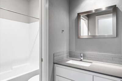 Main level bathroom adjacent to bedroom two.