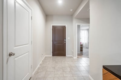 Bright, welcoming entryway featuring tile flooring and access to both living and dining areas.
