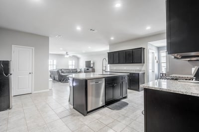 Spacious open-concept kitchen featuring modern appliances and a seamless flow to the main living area.