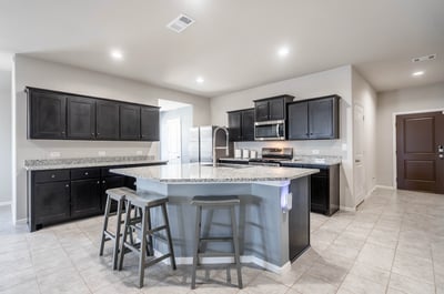 Bright and functional kitchen featuring modern appliances, ample counter space, and convenient seating for gatherings.