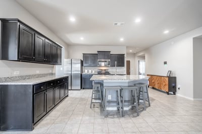 Modern kitchen featuring ample counter space, stainless steel appliances, and a spacious island for gatherings.