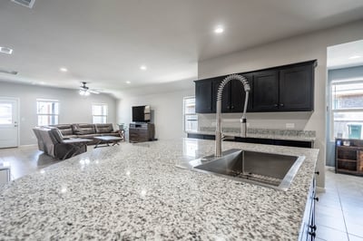 Spacious open-concept living area features modern finishes and a large island, perfect for entertaining.