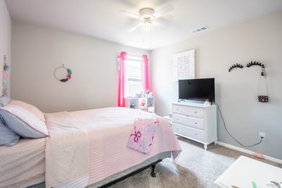 Bright and inviting bedroom featuring a cozy atmosphere, modern amenities, and abundant natural light.