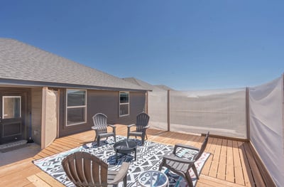 Spacious outdoor deck with comfortable seating, perfect for enjoying sunny days and relaxing gatherings.