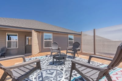 Spacious outdoor patio area with seating, perfect for gatherings and enjoying sunny days.