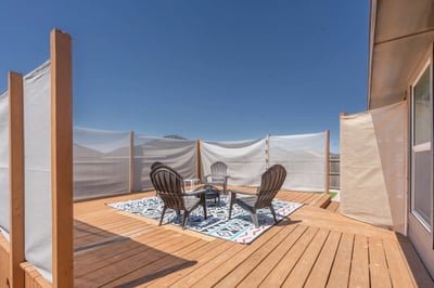 Spacious deck offering panoramic views, perfect for outdoor gatherings or relaxing in the sun.