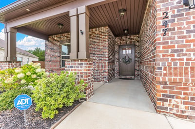 Welcoming brick façade entry with a spacious porch and well-maintained landscaping in a desirable neighborhood.