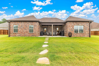 Spacious backyard with a well-maintained patio, perfect for outdoor gatherings and relaxation.
