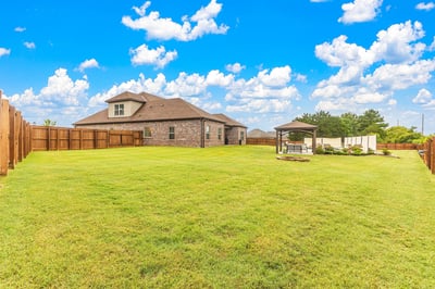 Spacious backyard with ample room for outdoor activities and a covered gazebo, perfect for gatherings.