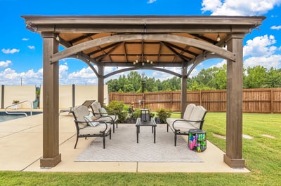 Discover this inviting outdoor space featuring a covered patio, perfect for relaxation and entertaining guests.