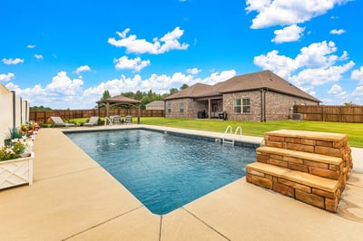 Inviting backyard oasis featuring a spacious pool, perfect for relaxation and outdoor entertaining.