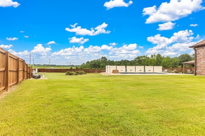 Spacious backyard with ample room for outdoor activities, perfect for creating your ideal retreat.