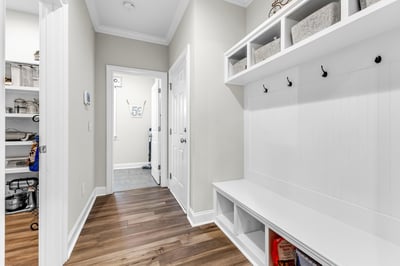 Bright and functional drop zone featuring built-in storage and hooks, perfect for organizing your space.
