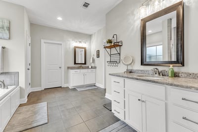 Spacious bathroom featuring dual sinks, ample counter space, and modern finishes, perfect for everyday convenience.