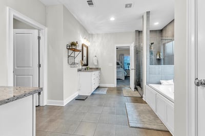 Spacious bathroom featuring a dual-sink vanity, modern shower, and bright, open layout for comfort.