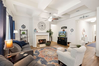 Inviting living room featuring a cozy fireplace, modern decor, and bright, airy ambiance for relaxation.