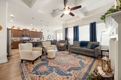 Spacious living area features high ceilings, modern fixtures, and a welcoming layout for entertaining.