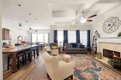Spacious open-concept living area featuring modern finishes and a cozy fireplace, perfect for entertaining.