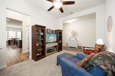 Bright and inviting living space with versatile layout, showcasing built-in shelving and cheerful decor.