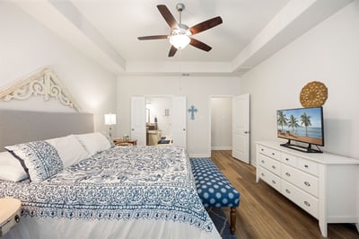 Bright and inviting bedroom featuring modern decor, a spacious layout, and a cozy seating area.